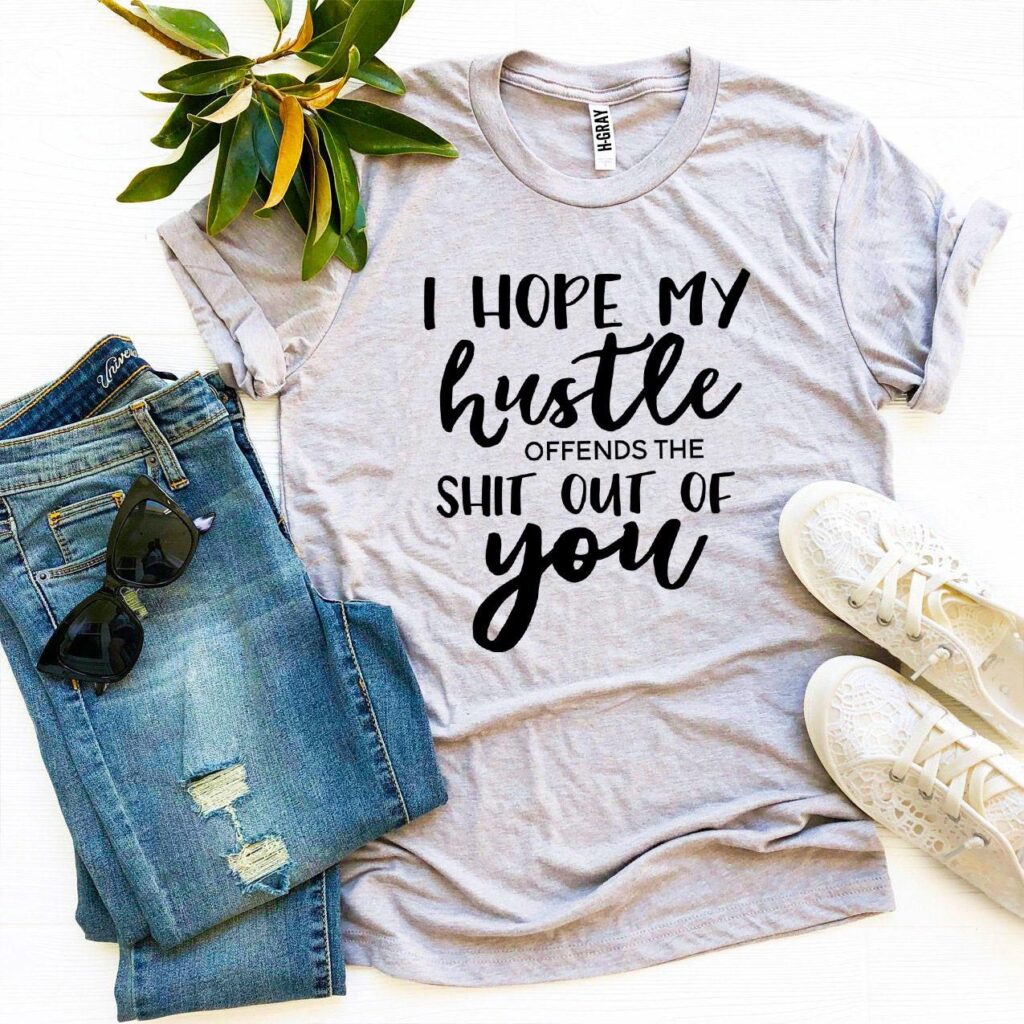I Hope My Hustle Offends T-shirt. The t-shirt is made of premium quality ring spun cotton for a great quality, soft feel, and comfortable retail fit. Our soft textile flex print gives a really high-end finish to any striking design. This high-quality print will not crack or fade which ensures your garment stays looking fantastic.